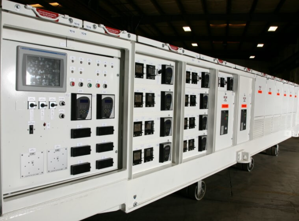 Large modular industrial control panel line with HMI and operator controls